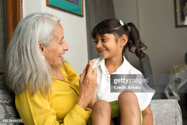 grandmother spending time with granddaughter - granddaughter stock pictures, royalty-free photos & images