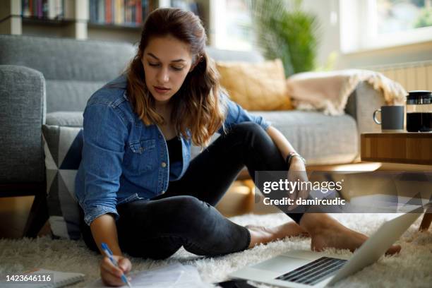 woman calculating finances at home - student loan stock pictures, royalty-free photos & images