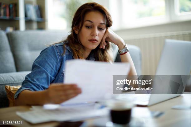 worried woman about home finances - student loan stock pictures, royalty-free photos & images