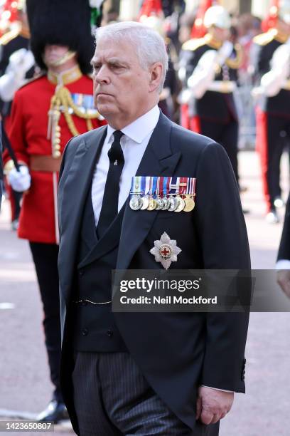 Prince Andrew, Duke of York follows the coffin carrying Queen Elizabeth II during the procession for the Lying-in State of Queen Elizabeth II on...