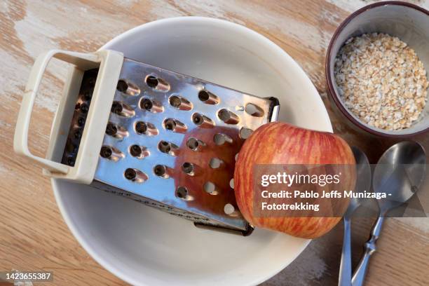 food grater next to an apple - grated apple stock pictures, royalty-free photos & images