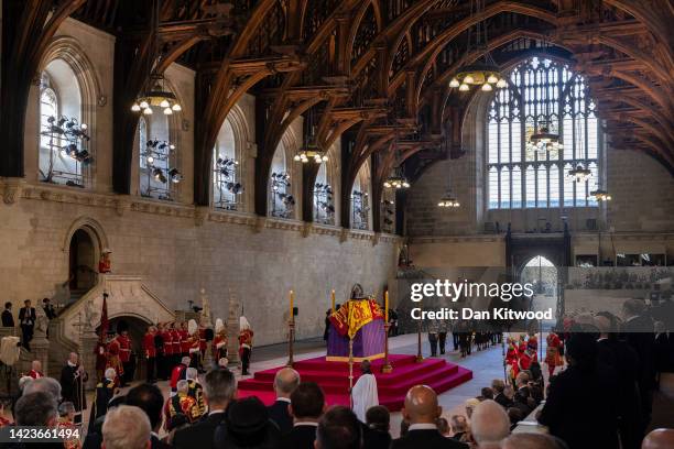 General view as King Charles III, Princess Anne, Princess Royal and Camilla, Queen Consort view the coffin carrying Queen Elizabeth II being laid to...