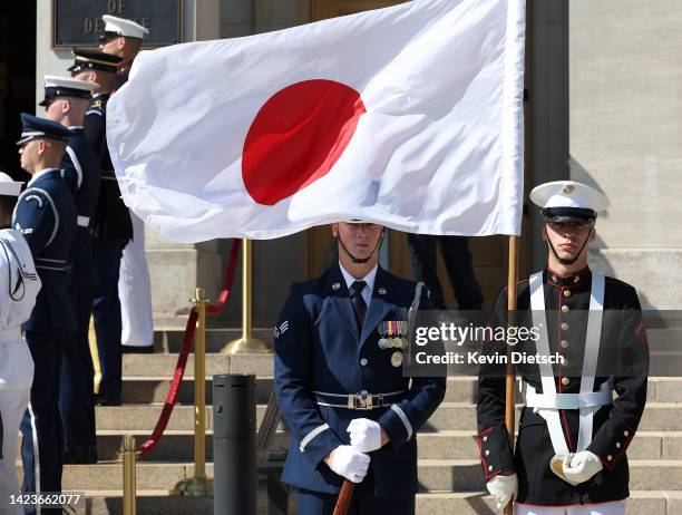 Members of a U.S. Military Honor Guard stand with the Japanese flag as U.S. Defense Secretary Lloyd Austin welcomes Japanese Defense Minister...