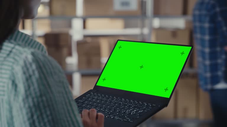 Display Cheaking Female Using a Laptop Computer with Green Screen Chromakey Mock Up ...