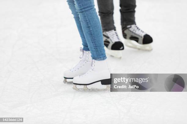 young adult couple ice skating - figure skating couple stock pictures, royalty-free photos & images