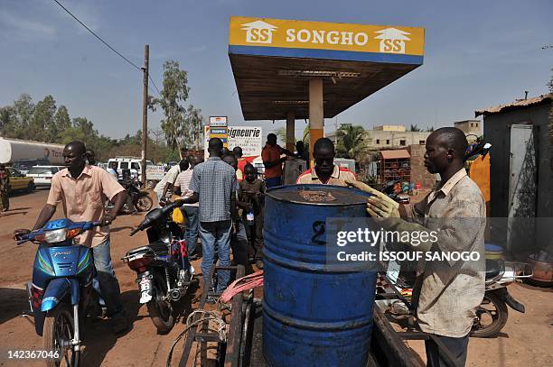 Residents queue at a petrol station to buy fuel on April 3, 2012 in Bamako. Islamists gained ground in northern Mali, jostling with Tuareg rebels for...