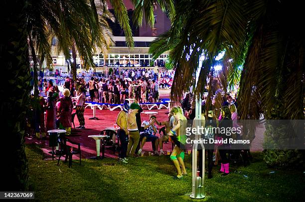 British students in fancy dress party at the swimming pool of their hotel during the second night of parties during the SalouFest on April 2, 2012 in...