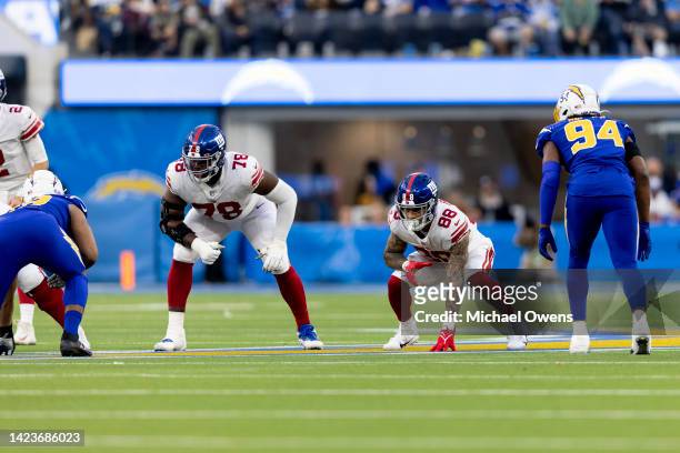 New York Giants offensive tackle Andrew Thomas and Evan Engram of New York Giants line up against the Los Angeles Chargers during an NFL football...