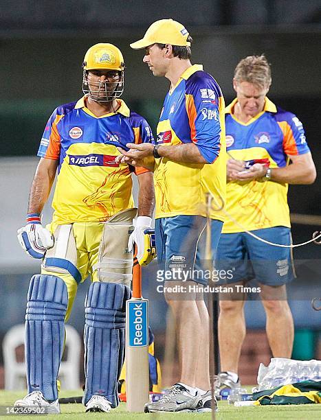 Dhoni of the Chennai Super Kings talks with coach Stephen Fleming as bowling coach Andy Bichel looks on during net practice at M.A Chidambaram...