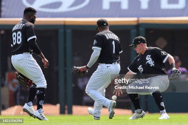 Luis Robert, Elvis Andrus and Andrew Vaughn of the Chicago White Sox drop a hit by Ryan McMahon of the Colorado Rockies during the first inning at...