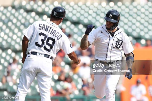 Javier Baez of the Detroit Tigers celebrates his solo home run in the seventh inning with third base coach Ramon Santiago while playing the Houston...