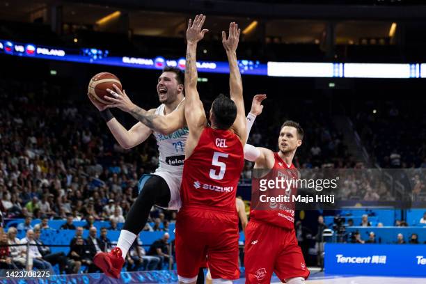 Luka Doncic of Slovenia in action against Aaron Cel and Mateusz Ponitka of Poland during the FIBA EuroBasket 2022 quarterfinal match between Slovenia...
