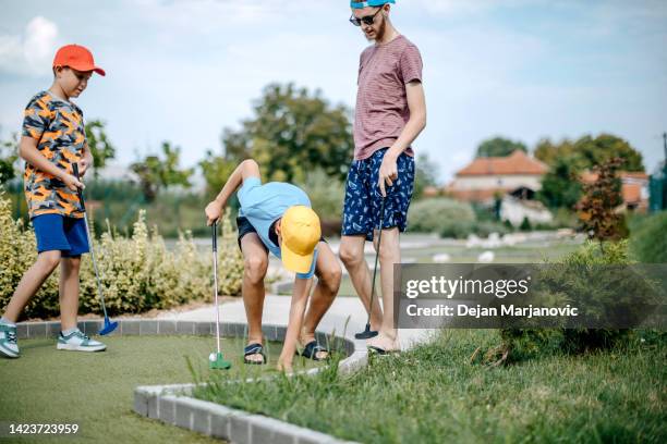 boys playing mini golf - miniature golf stock pictures, royalty-free photos & images