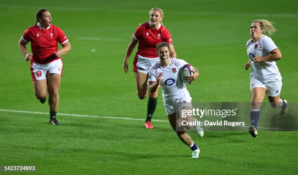 Helena Rowland of England breaks clear to score her first try during the Women's international match between England Red Roses and Wales at Ashton...