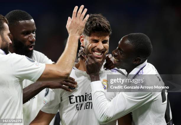 Marco Asensio of Real Madrid celebrates with teammates after scoring their side's second goal during the UEFA Champions League group F match between...