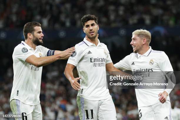 Marco Asensio of Real Madrid celebrates with teammates Nacho Fernandez and Federico Valverde after scoring their side's second goal during the UEFA...