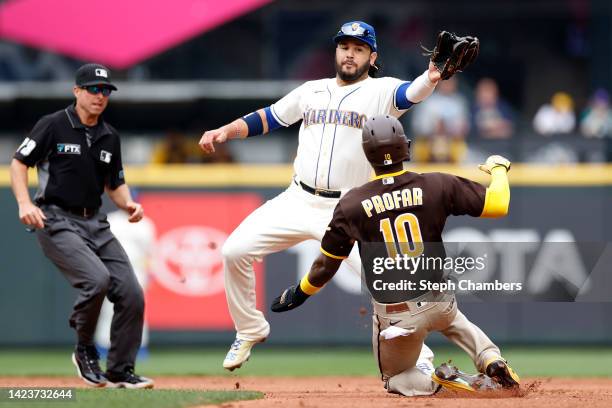 Jurickson Profar of the San Diego Padres reaches second base against Eugenio Suarez of the Seattle Mariners during the third inning at T-Mobile Park...