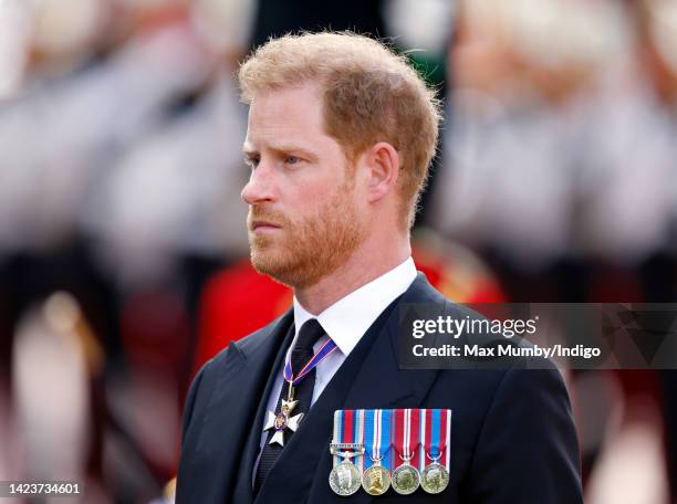 Prince Harry, Duke of Sussex walks behind Queen Elizabeth II's coffin as it is transported on a gun carriage from Buckingham Palace to The Palace of...