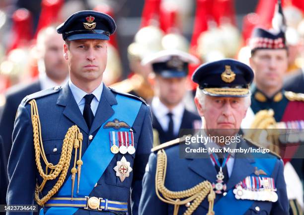 Prince William, Prince of Wales and King Charles III walk behind Queen Elizabeth II's coffin as it is transported on a gun carriage from Buckingham...