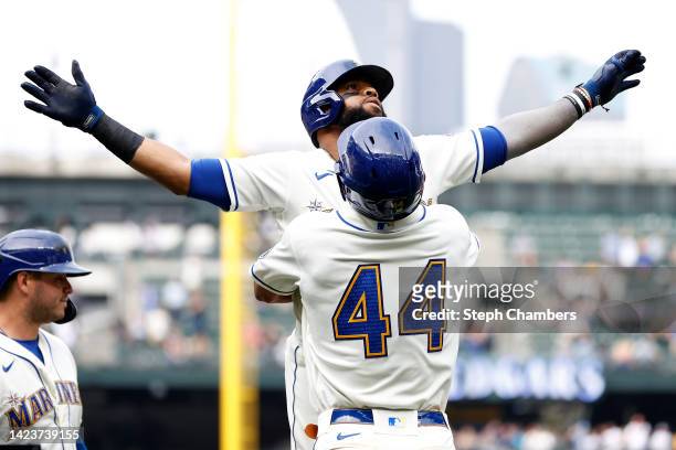 Carlos Santana celebrates his three run home run with Ty France and Julio Rodriguez of the Seattle Mariners during the fifth inning against the San...