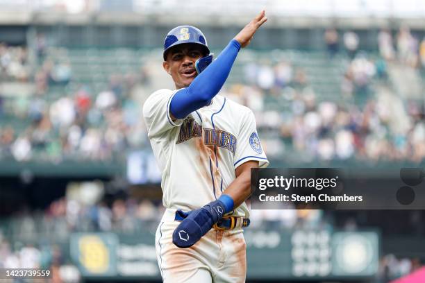 Julio Rodriguez of the Seattle Mariners celebrates a three run home run by Carlos Santana during the fifth inning against the San Diego Padres at...