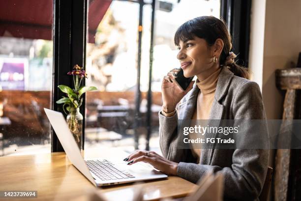 young business woman talking on mobile phone call at coffee shop - fringing stock pictures, royalty-free photos & images