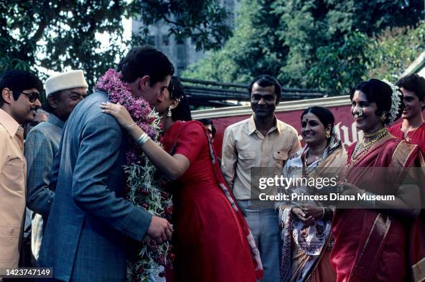 Watched by onlookers, Prince Charles, Prince of Wales receives a kiss from Indian actress Padmini Kolhapure, during the former's visit to the...