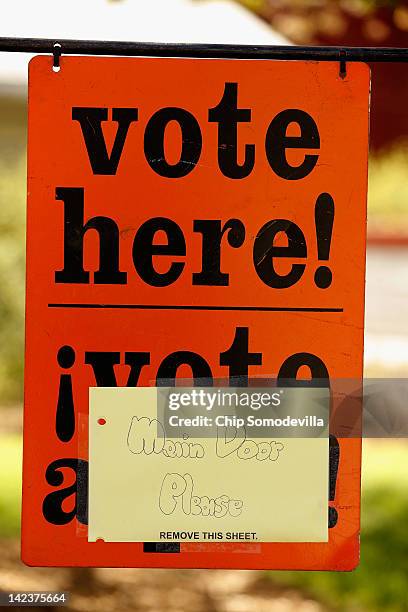 Sign directs voters during the presidential primary election at the Agricultural History Farm Park April 3, 2012 in Derwood, Maryland. Republican...