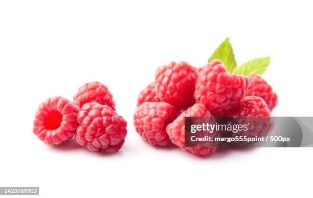 close-up of raspberries against white background - framboos stockfoto's en -beelden