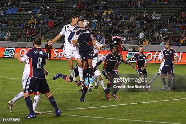 Ryan Guy of the New England Revolution and Andrew Boyens of the Los Angeles Galaxy go up to head the ball during the MLS match at The Home Depot...