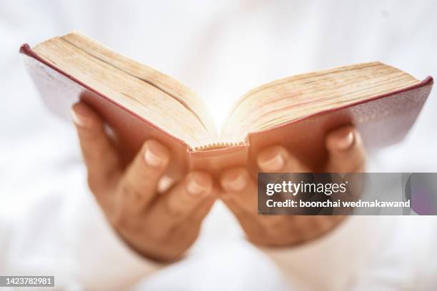 close up hands of a priest holding bible. - pastor stock pictures, royalty-free photos & images