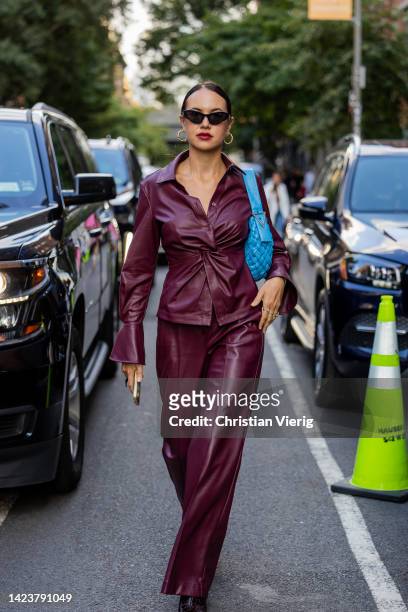 Karina Bik wearing burgundy leather pants and button shirt outside Jonathan Simkhai on September 13, 2022 in New York City.