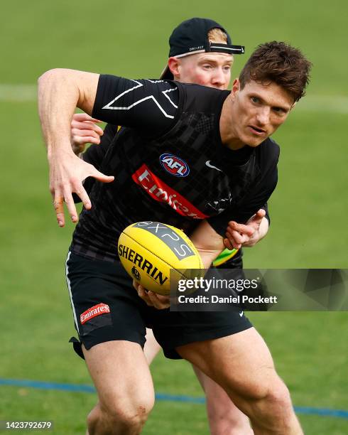 Brody Mihocek of the Magpies is tackled by John Noble of the Magpies during a Collingwood Magpies AFL training session at Olympic Park Oval on...