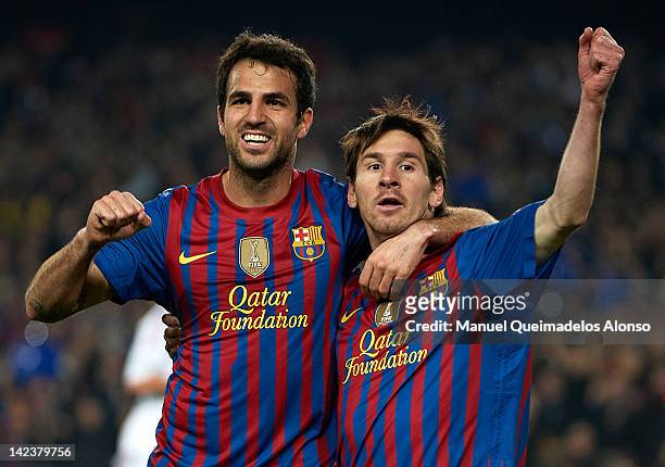 Lionel Messi of Barcelona celebrates with team-mate Cesc Fabregas after scoring the opening goal during the UEFA Champions League quarter-final...