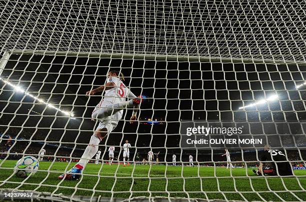 Milan's French defender Philippe Mexes kicks the ball after Barcelona's Argentinian forward Lionel Messi scored a penalty during the Champions League...