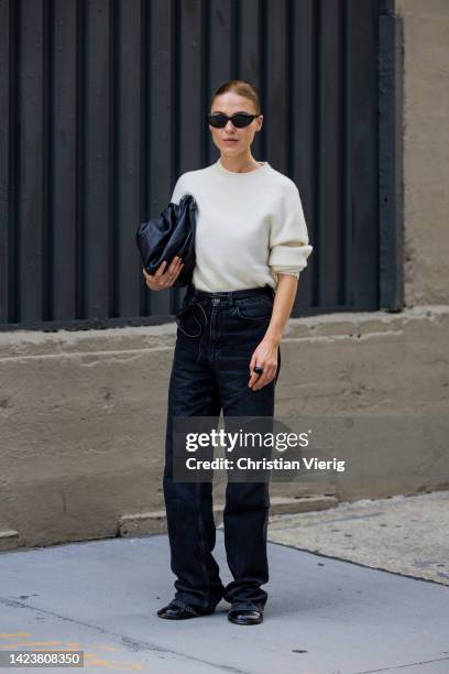 Sophia Roe wearing black denim jeans, knit, black bag Bottega Veneta outside Cos on September 13, 2022 in New York City.