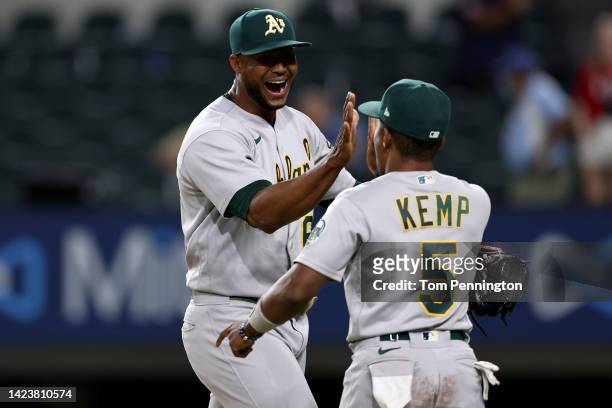 Domingo Acevedo of the Oakland Athletics celebrates with Tony Kemp of the Oakland Athletics after getting the 8-7 save against the Texas Rangers at...