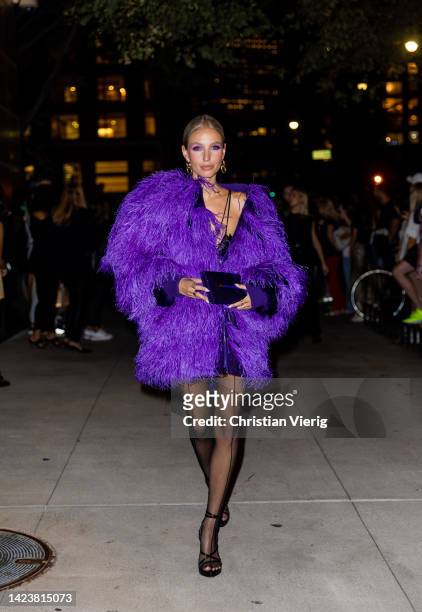 Leonie Hanne wearing tights, purple coat outside Tom Ford on September 14, 2022 in New York City.