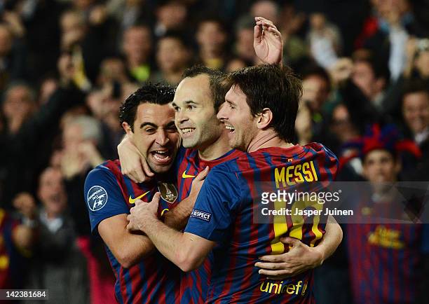 Andres Iniesta of FC Barcelona celebrates scoring with his teammates Lionel Messi and Xavi Hernandez during the Champions League quarter-final second...