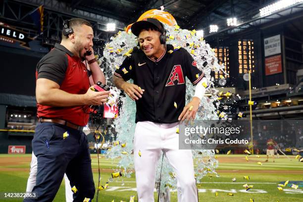 Sergio Alcantara of the Arizona Diamondbacks is doused with water after hitting the game winning three run home run during the bottom of the 10th...