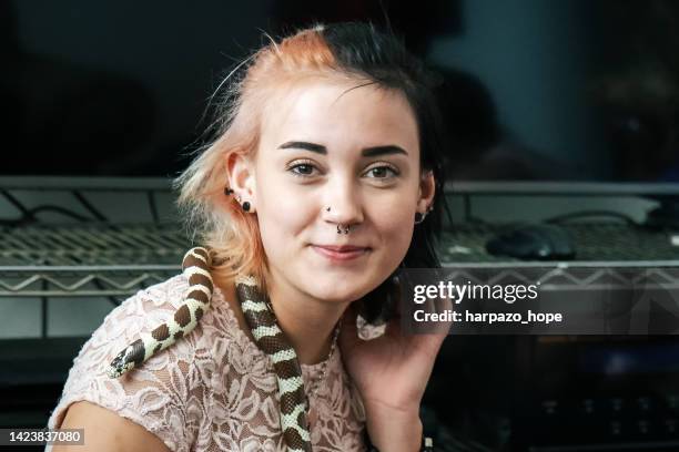 teenage girl with her pet snake. - piercing stock-fotos und bilder