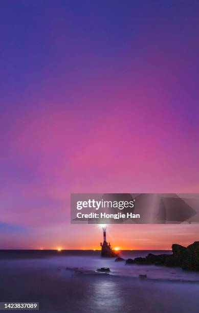 lighthouse at sea, clouds at sunset time. - lighthouse sunset stock pictures, royalty-free photos & images