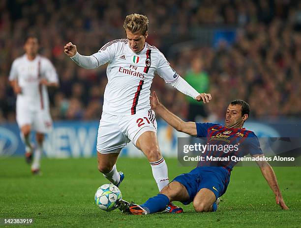 Javier Mascherano of Barcelona competes for the ball with Maxi Lopez of AC Milan during the UEFA Champions League quarter-final second leg match...