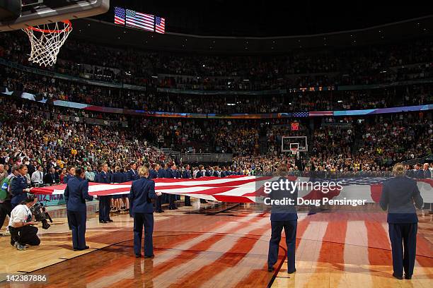 Air Force Cadets hold a giant American Flag across the court for the performacne of the National Anthem between the Baylor Bears and the Notre Dame...