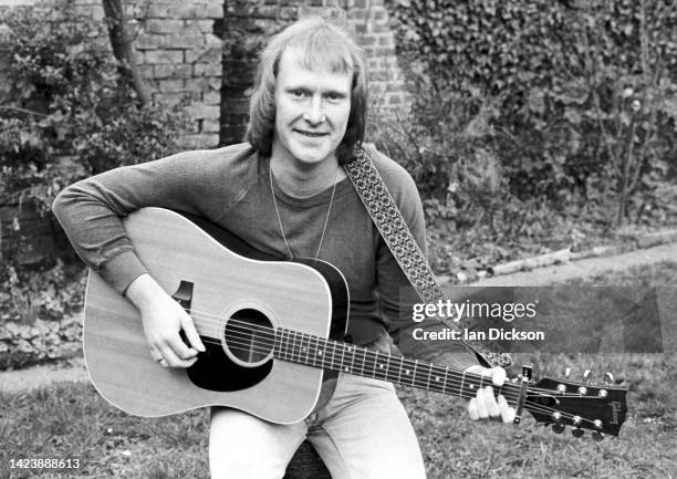 Dennis Waterman, portrait with acoustic guitar, London, 1975.