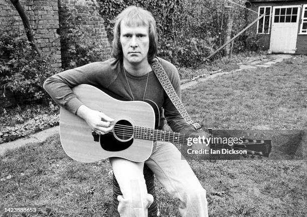 Dennis Waterman, portrait with acoustic guitar, London, 1975.