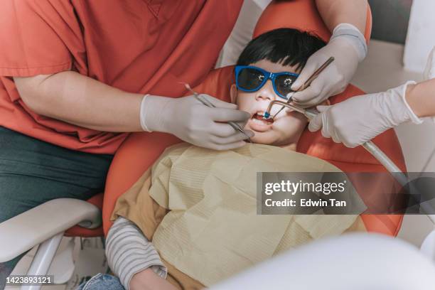 asian chinese boy routine dental checkup - suction tube stock pictures, royalty-free photos & images