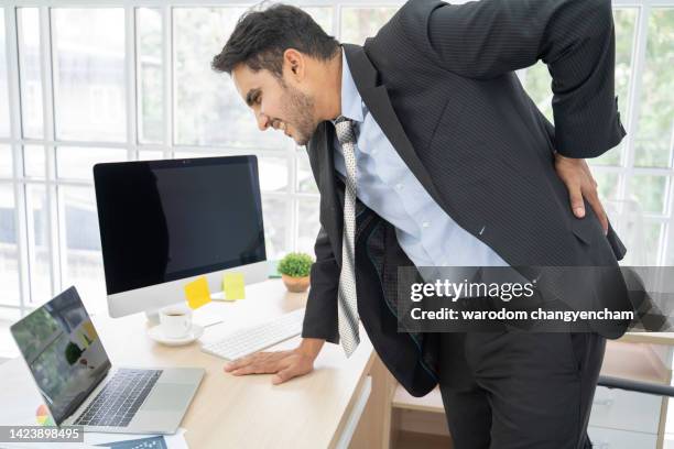 all this sitting is putting strain on my back. - man lower back stock pictures, royalty-free photos & images