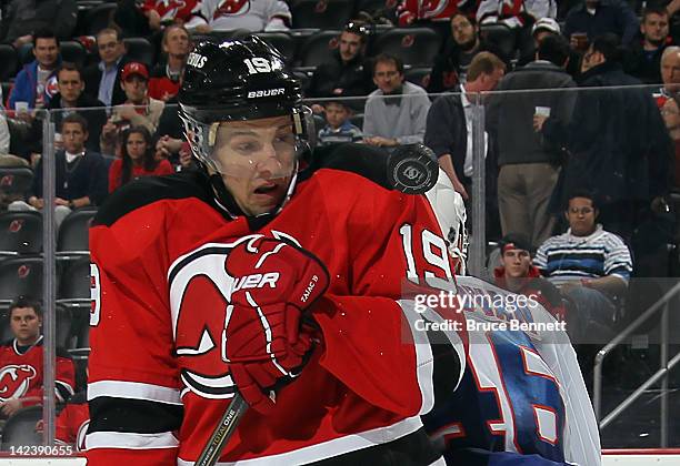 Travis Zajac of the New Jersey Devils watches as the puck flies past him during his game against the New York Islanders at the Prudential Center on...