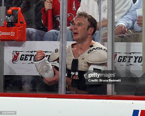 Cam Janssen of the New Jersey Devils sits in the penalty box following a fight with Micheal Haley of the New York Islanders at the Prudential Center...